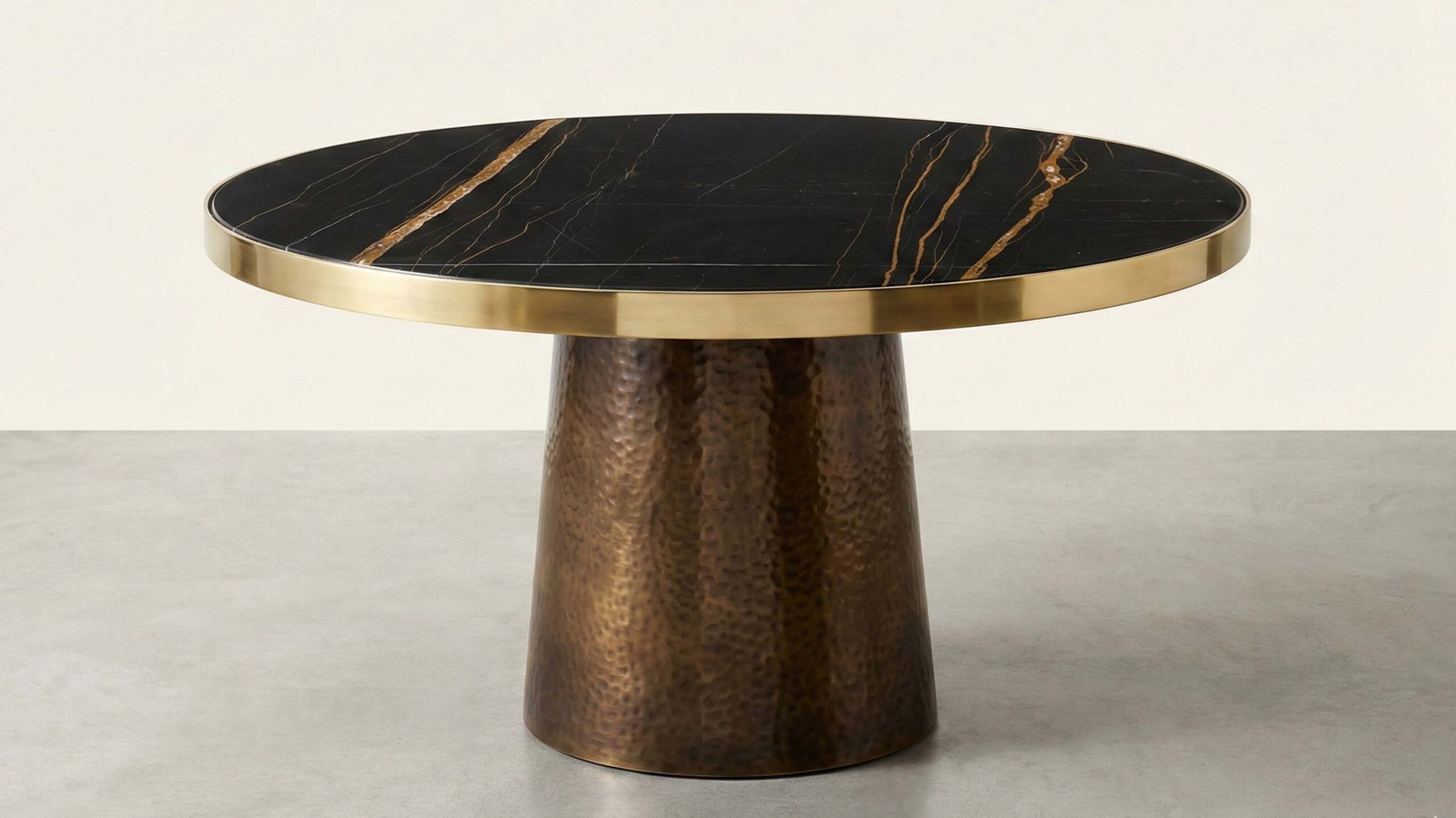 Polished Sahara Noir marble top on a round coffee table showing how lighting reflections change across the surface.