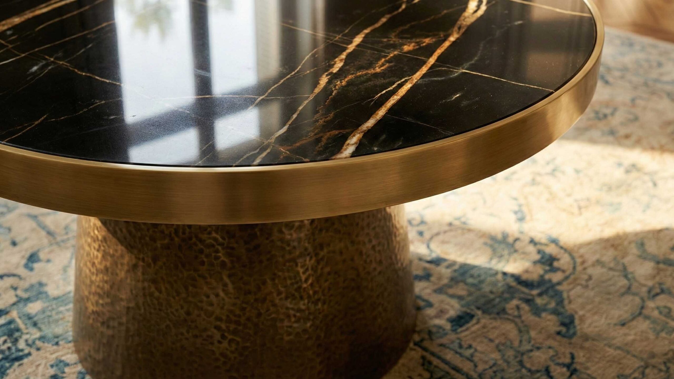 Sahara Noir black marble coffee table paired with wool rug and oak tones for balanced contrast in a contemporary interior.