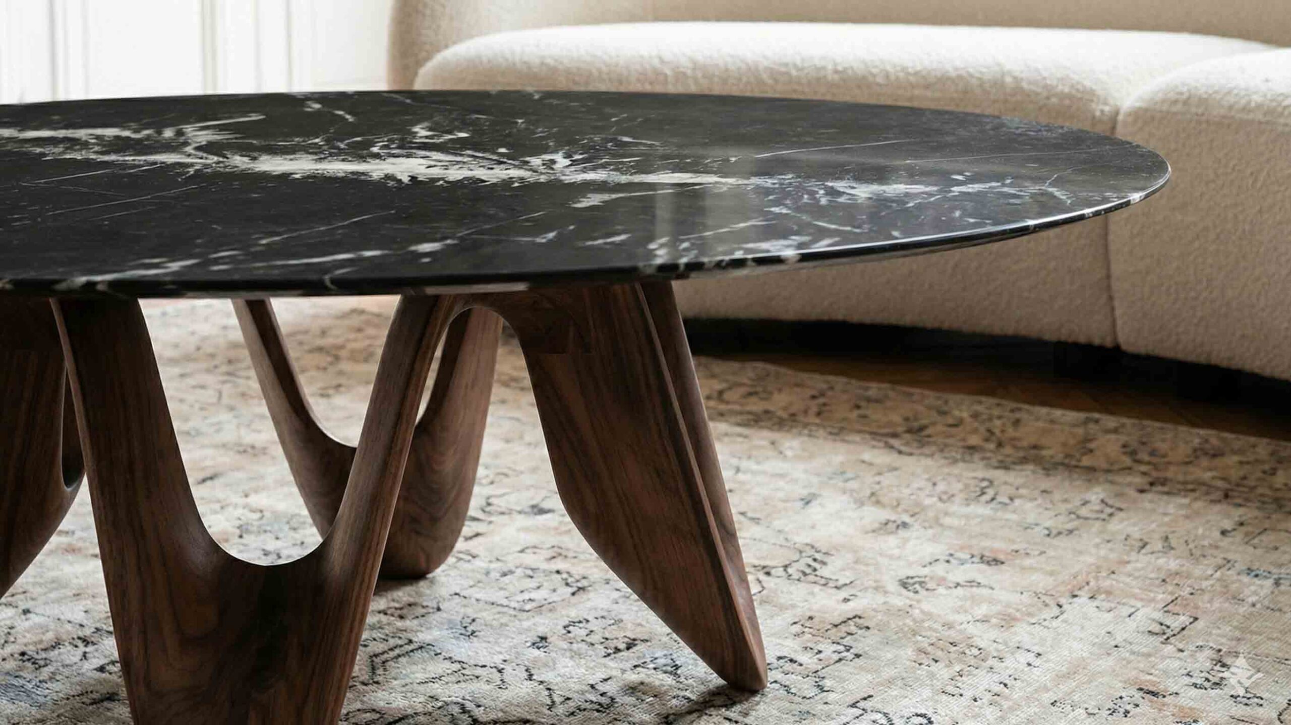 Stone coffee table in Nero Marquina marble creating strong contrast in modern living space.