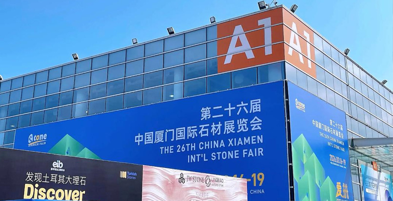 First-time buyers at Xiamen Stone Fair reviewing the hall map and planning an efficient visit strategy